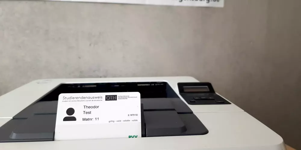 The OTH Regensburg card placed on a printer.
