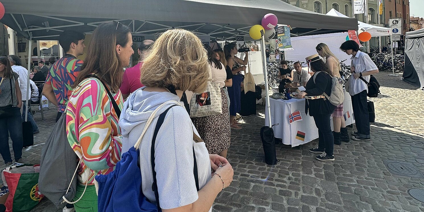 Mehrere Personen an einem Infostand.