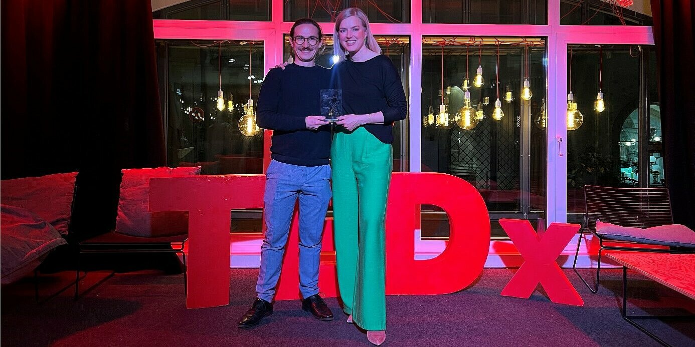 Zwei Personen halten einen Award.