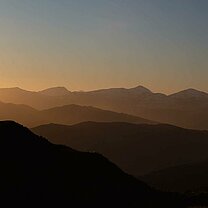 Mountain sunset with mountain climber.