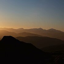 Mountain sunset with mountain climber.