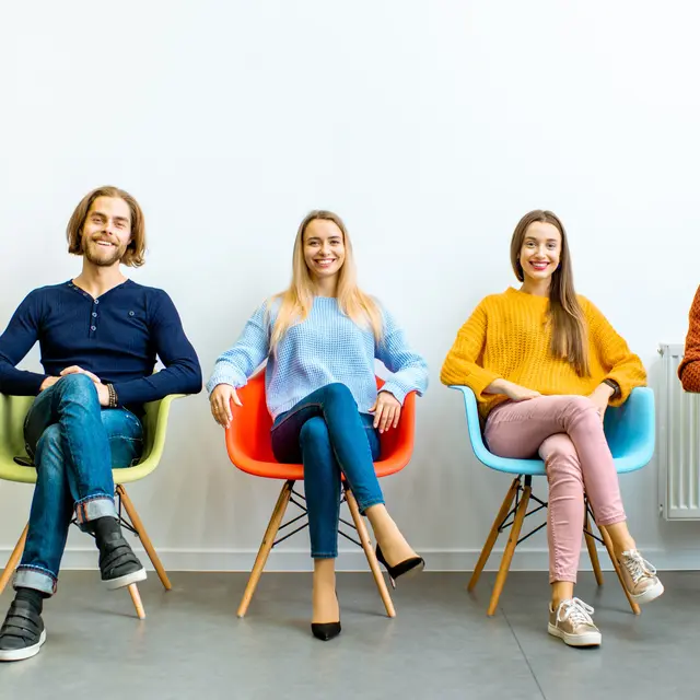 Young people sitting on chairs