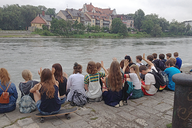 Die Schüler sitzen nach Abschluss der Schnitzeljagd an der Donau. Die Schüler sitzen nach Abschluss der Schnitzeljagd an der Donau.